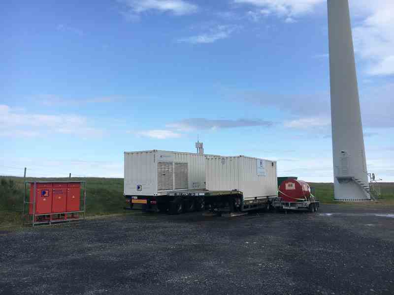 2100kVA generator with fuel tank next to wind turbine