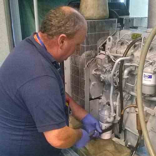 Engineer replacing the generator filters