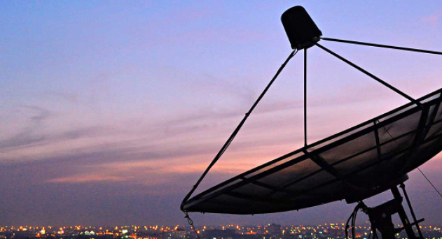 Satellite dish overlooking the city)