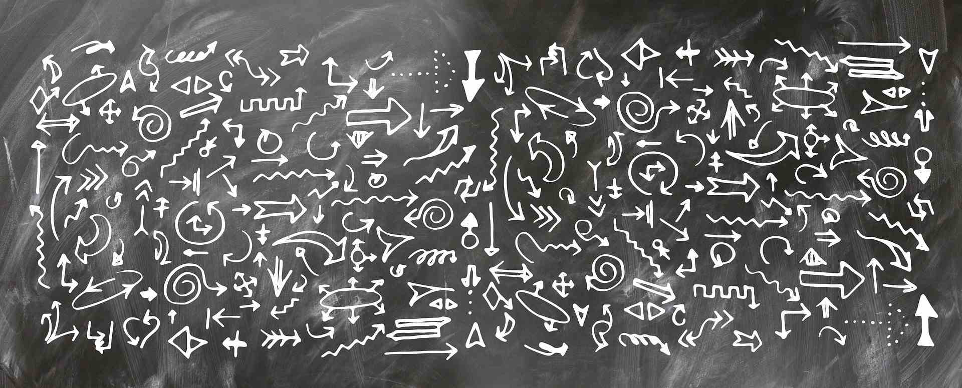 Various arrows drawn on a chalkboard