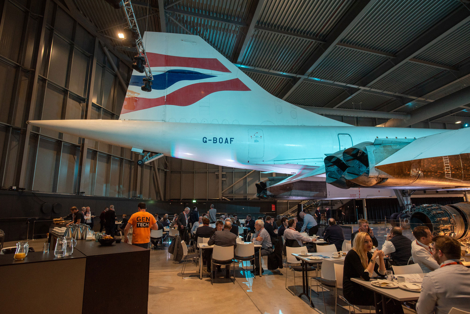 People eating at the GenTech2019 conference under a Concorde plane tail